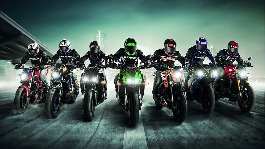 Group of Motorcyclists Riding in Formation on a City Highway at Night HD wallpaper