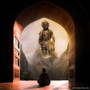 Silhouette of a person meditating before a colossal golden deity statue in a misty mountain landscape HD phone wallpaper
