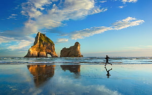 Woman Running on Wet Sand with Sea Stacks and Reflections Under a Blue Sky, Woman Running On Beach HD wallpaper