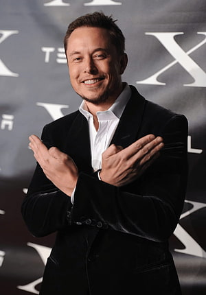 Elon Musk in Black Velvet Suit Clapping at a Formal Event HD phone wallpaper