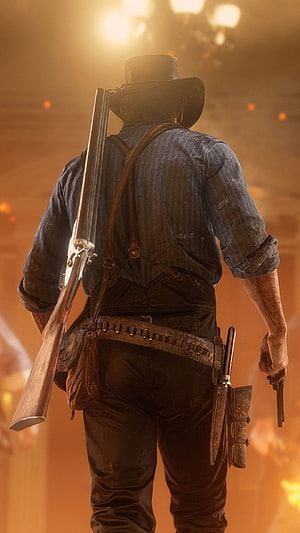 Red Dead Redemption 2 cowboy silhouette with rifle and revolver against fiery sunset backdrop HD phone wallpaper