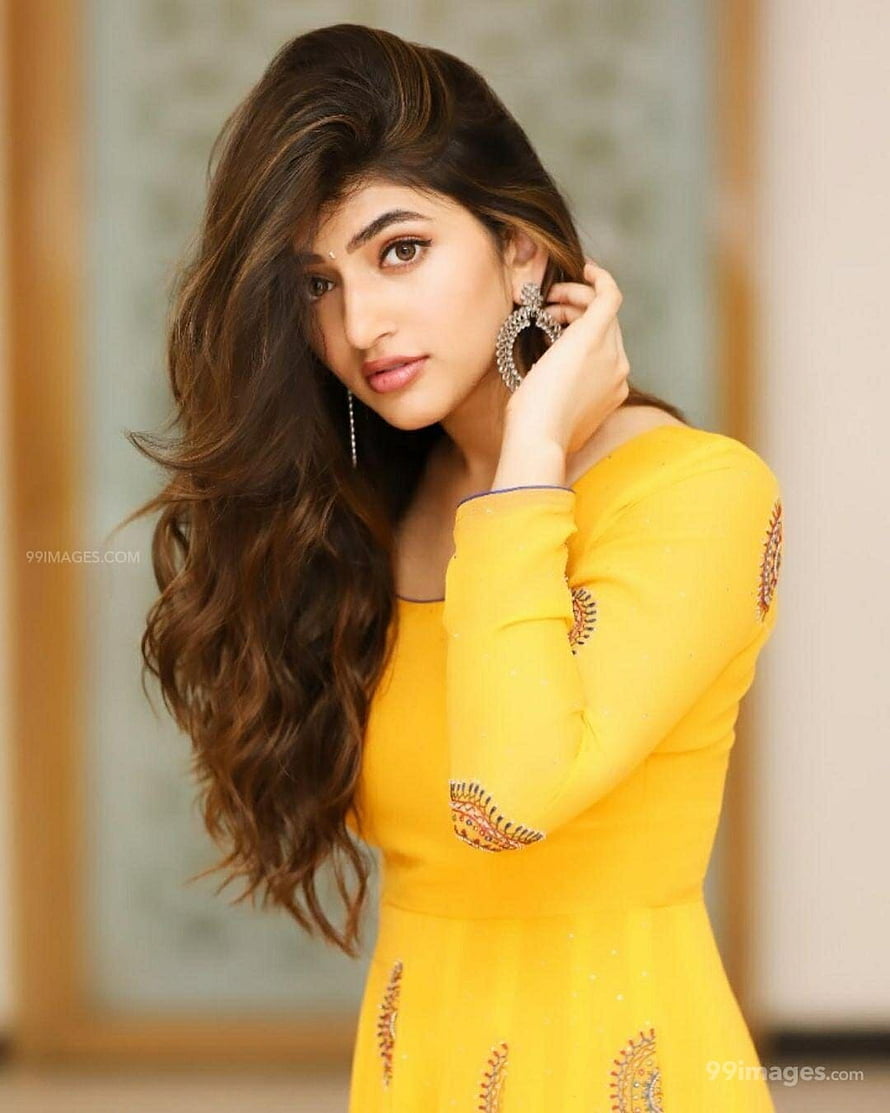 Pooja Hegde in a vibrant yellow traditional dress with intricate embroidery and elegant jewelry HD phone wallpaper