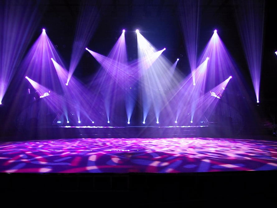 Vibrant Purple Concert Stage With Dramatic Spotlight Beams And Patterned Floor Lighting HD wallpaper