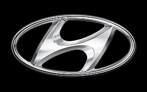 Sleek Chrome Hyundai Emblem on Black Background HD wallpaper