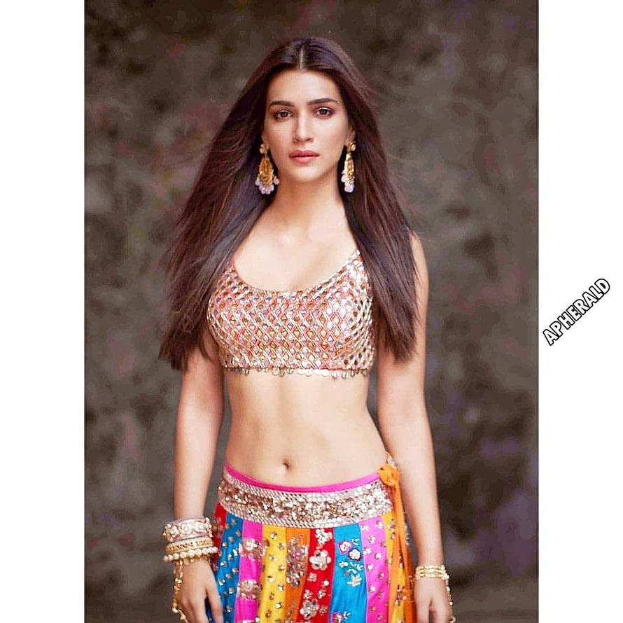 Kriti Sanon in a vibrant traditional Indian outfit with a colorful skirt and embellished blouse HD phone wallpaper