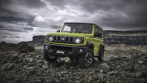 Lime Green Suzuki Jimny Off-Road SUV on Rocky Terrain Under Dramatic Stormy Sky HD wallpaper