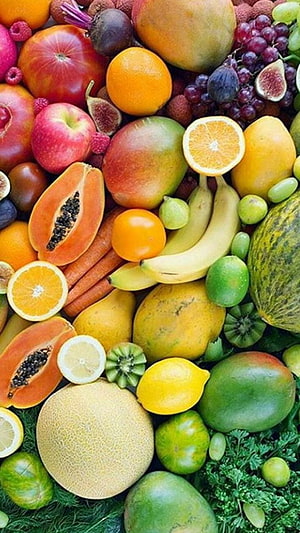 Vibrant Assortment of Fresh Fruits and Vegetables Arranged on Green Bedding HD phone wallpaper