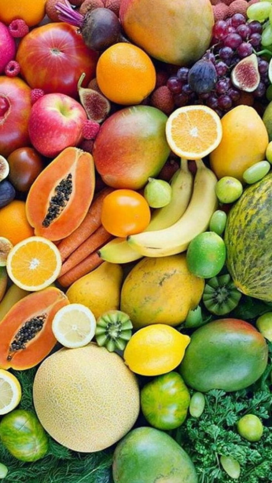 Vibrant Assortment of Fresh Fruits and Vegetables Arranged on Green Bedding HD phone wallpaper