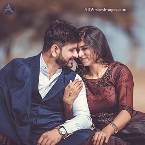 Romantic Indian couple in formal attire sharing an intimate moment outdoors HD phone wallpaper