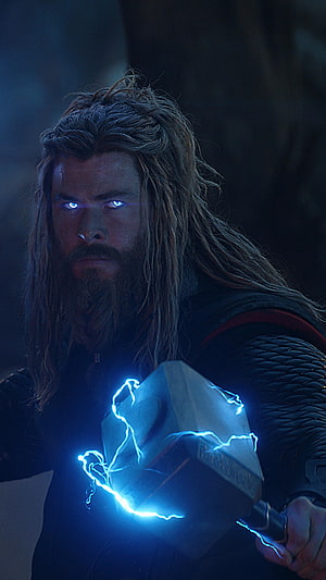 Thor from Avengers Endgame holding Mjolnir with glowing blue lightning and intense eyes HD phone wallpaper