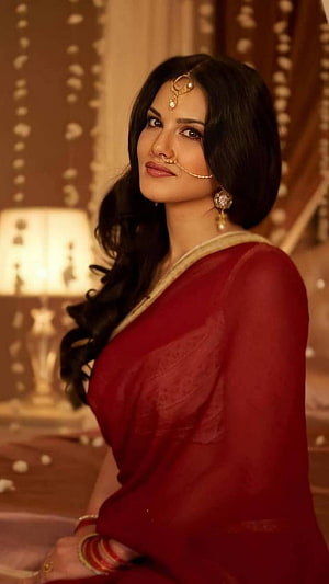 Sunny Leone in a stunning red saree with traditional Indian jewelry and bridal makeup HD phone wallpaper