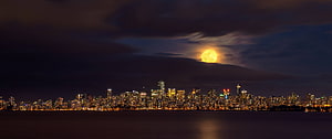 Full Moon Rising Over Vancouver Skyline at Night With City Lights Reflecting on Water HD wallpaper