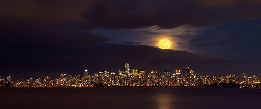 Full Moon Rising Over Vancouver Skyline at Night With City Lights Reflecting on Water HD wallpaper