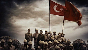 Turkish Soldiers Standing on Rocky Battlefield Under Stormy Sky with National Flag HD wallpaper