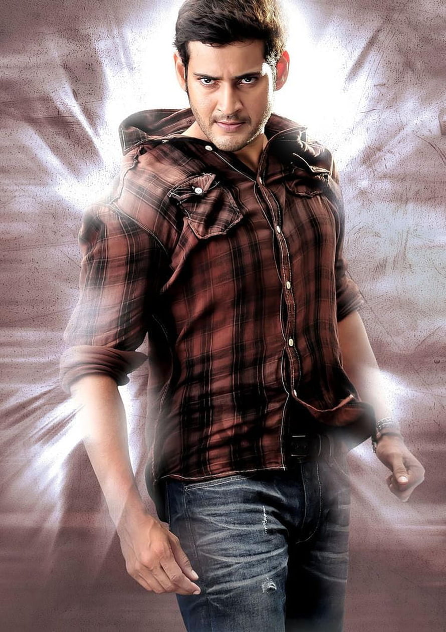 Mahesh Babu in a plaid shirt and jeans with a dramatic light burst background HD phone wallpaper