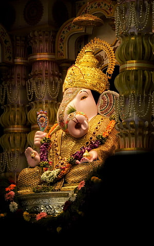 Golden Ganesha Idol Adorned With Jewels And Floral Garlands In Temple HD phone wallpaper