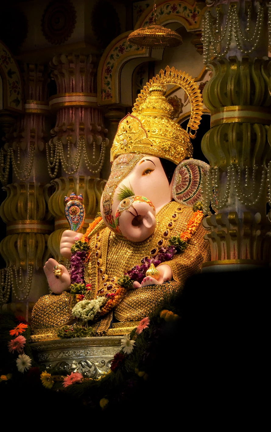 Golden Ganesha Idol Adorned With Jewels And Floral Garlands In Temple HD phone wallpaper