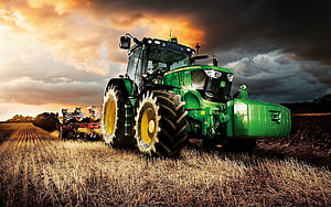 Green John Deere Tractor Plowing a Golden Wheat Field at Sunset HD wallpaper