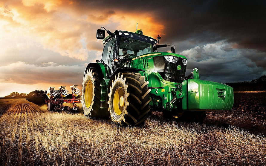 Green John Deere Tractor Plowing a Golden Wheat Field at Sunset HD wallpaper