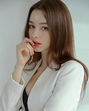 Dasha Taran in a White Blazer with Long Brown Hair and Soft Studio Lighting HD phone wallpaper