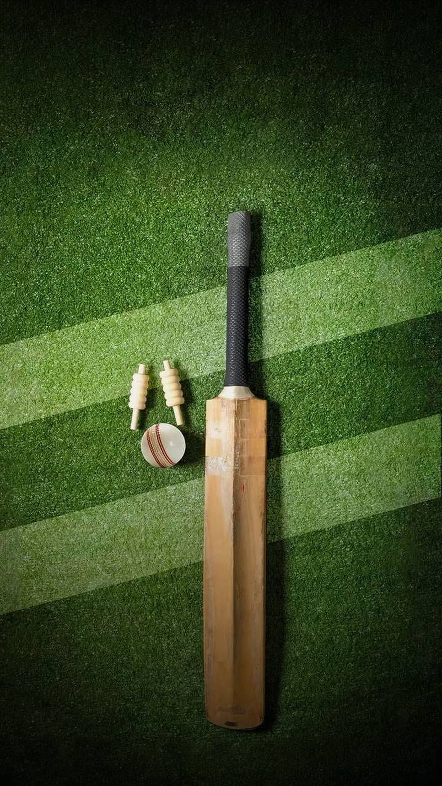 Cricket bat, ball, and stumps arranged on a green artificial turf field HD phone wallpaper