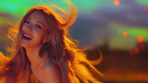 Rosé from BLACKPINK with flowing hair in warm golden light and colorful bokeh background HD wallpaper