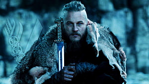 Ragnar Lothbrok from Vikings holding sword in fur cloak HD wallpaper