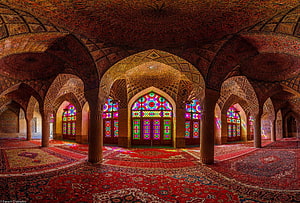 Ornate Persian Mosque Interior with Intricate Stained Glass Windows and Patterned Carpet HD wallpaper