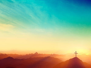 Silhouette of a Christian Cross on a Mountain Peak at Sunset HD wallpaper