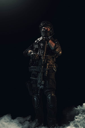 Tactical Soldier in Black Gear Holding Assault Rifle Amidst Smoke HD phone wallpaper