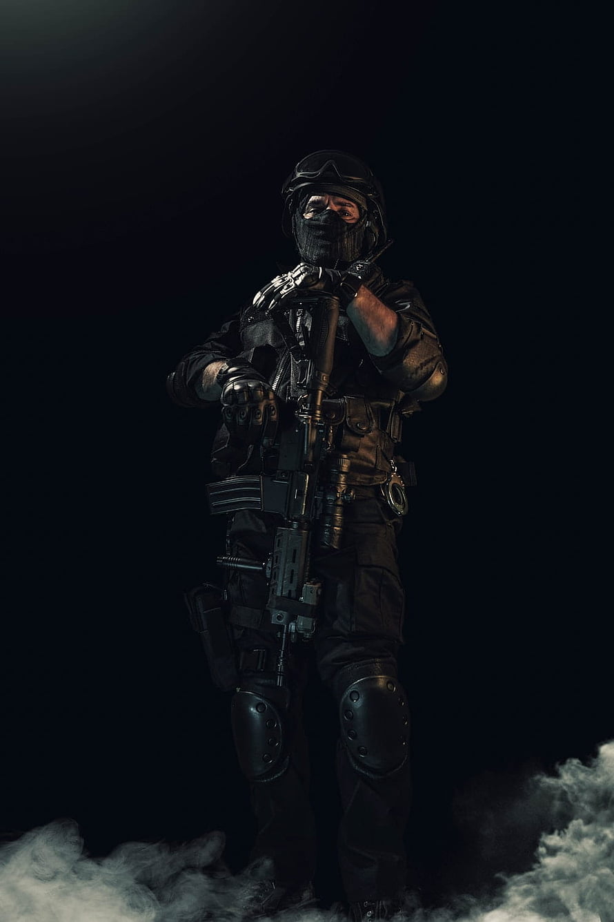 Tactical Soldier in Black Gear Holding Assault Rifle Amidst Smoke HD phone wallpaper