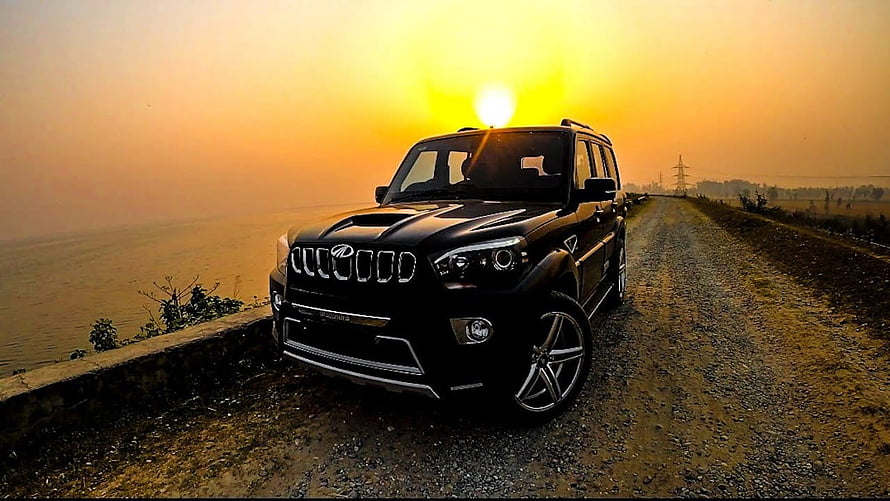 Black Mahindra Scorpio SUV Parked on Gravel Road at Sunset HD wallpaper