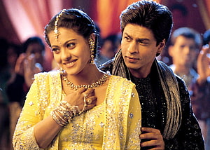 Shah Rukh Khan and Kajol in traditional Indian attire at a festive celebration HD wallpaper