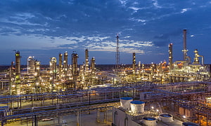 Illuminated Oil Refinery Complex at Dusk with Industrial Towers and Piping HD wallpaper