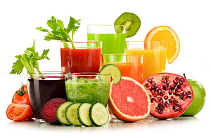 Colorful Fresh Fruit and Vegetable Juices with Citrus, Pomegranate, and Cucumber HD wallpaper