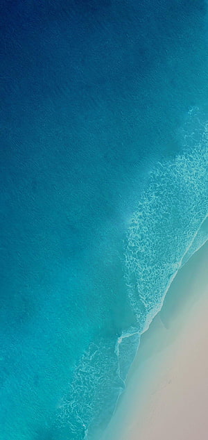 Aerial View of Turquoise Ocean Waves Washing Over White Sandy Beach HD phone wallpaper