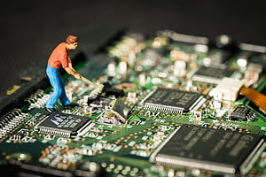 Miniature Worker Repairing Motherboard Circuit Board with Tools HD wallpaper