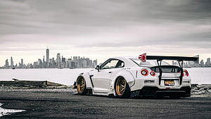 Liberty Walk Nissan Skyline R34 GT-R Widebody with Gold Wheels and Rear Wing HD wallpaper