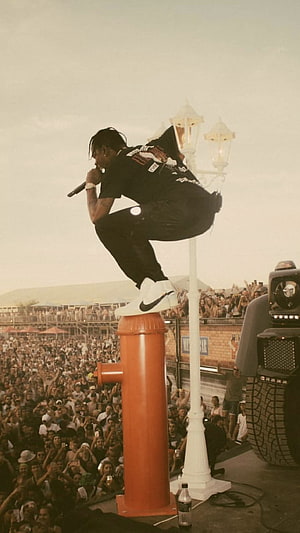 Travis Scott performing live concert on stage with crowd HD phone wallpaper