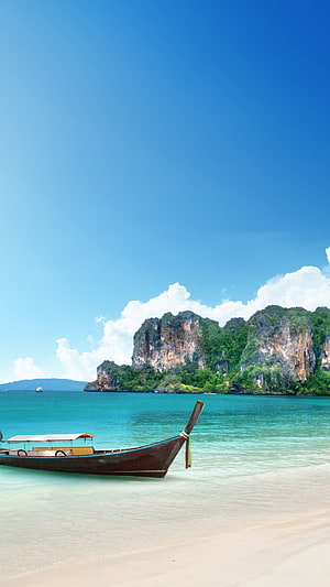 Traditional Longtail Boat on a Pristine Thai Beach with Limestone Cliffs and Turquoise Water HD phone wallpaper