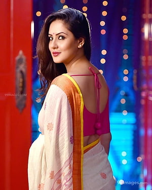 Puja Banerjee in a white and orange saree with a pink blouse against a festive bokeh background HD phone wallpaper