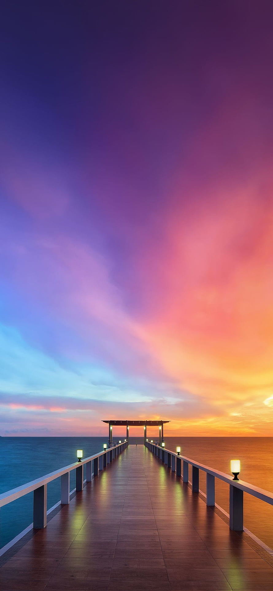 Serene Wooden Pier Extending Into The Ocean Under A Vibrant Purple And Orange Sunset Sky HD phone wallpaper