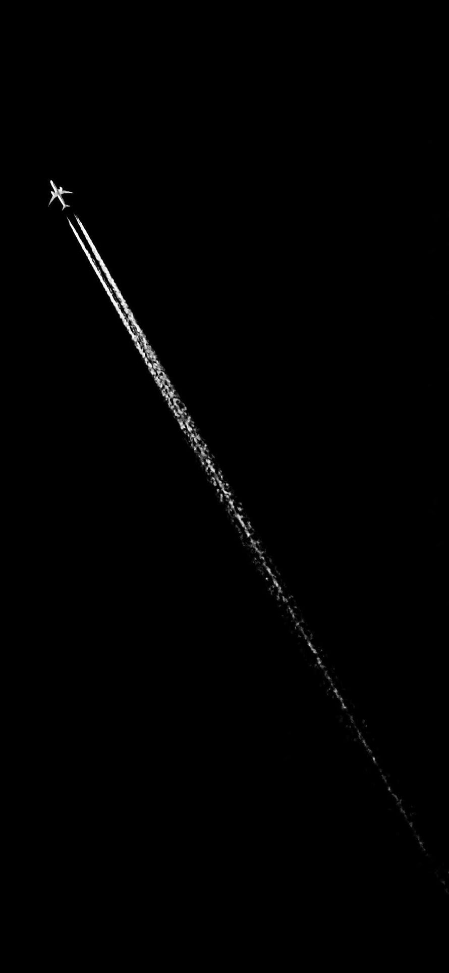 Minimalist Airplane Silhouette with Contrail Against Pure Black Sky HD phone wallpaper