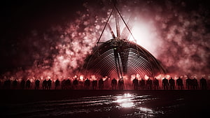 Silhouetted Figures Facing a Massive Alien Structure in a Red Hazy Atmosphere HD wallpaper