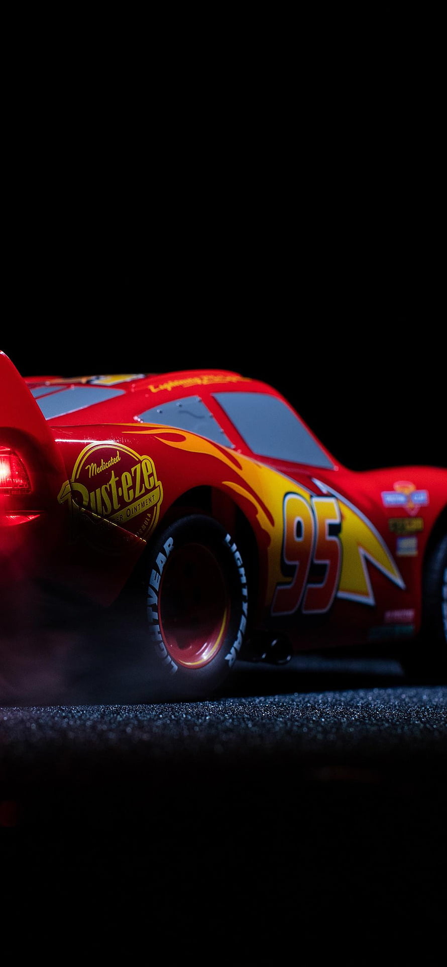 Lightning McQueen Number 95 Rust-eze Racing Car Close-Up on Dark Asphalt HD phone wallpaper