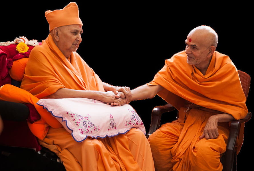 Two Hindu monks in orange robes holding hands in a moment of spiritual connection and respect HD wallpaper