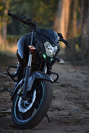 Black Bajaj Pulsar NS200 Motorcycle Parked on a Forest Trail at Dusk HD phone wallpaper