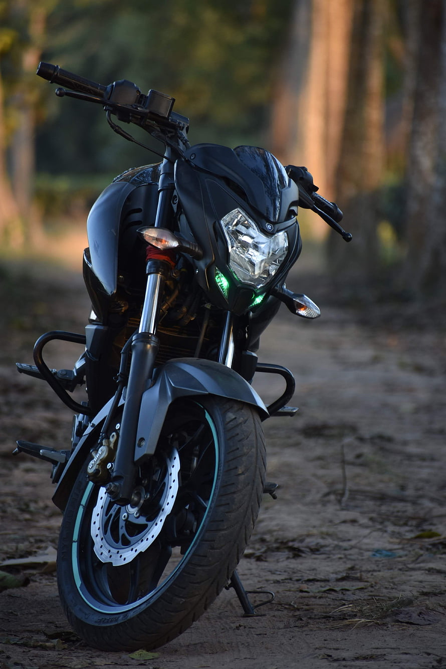 Black Bajaj Pulsar NS200 Motorcycle Parked on a Forest Trail at Dusk HD phone wallpaper