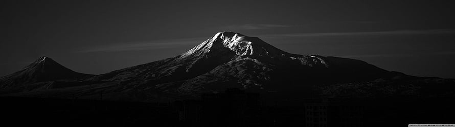 Dramatic Black and White Panorama of Snow-Capped Volcanic Peaks at Dusk HD wallpaper