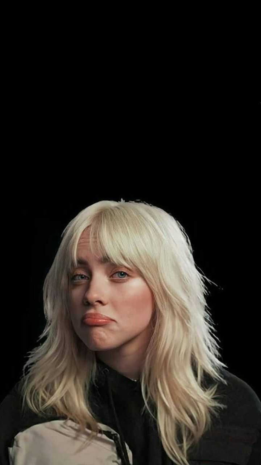 Billie Eilish Portrait With Blonde Hair And Pouting Expression On Black Background HD phone wallpaper